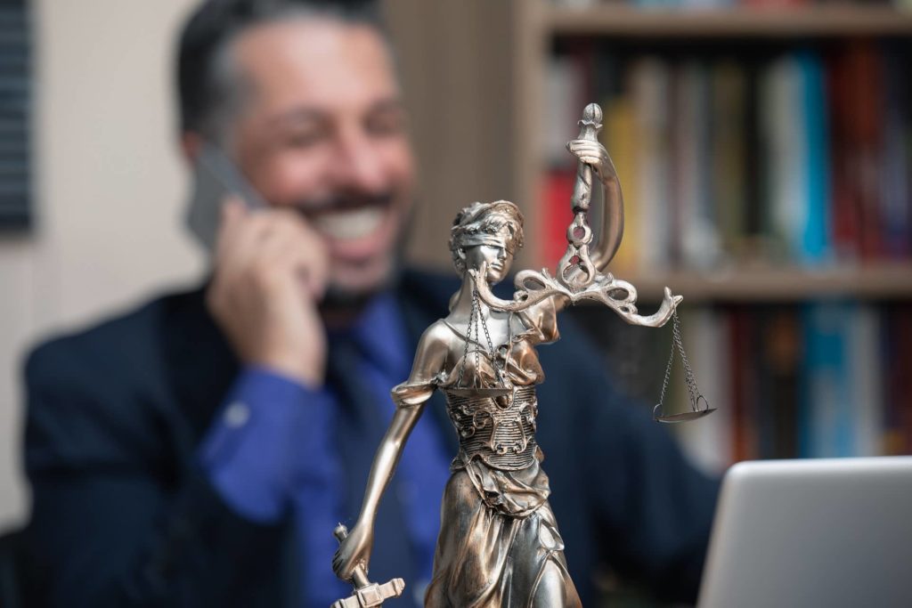 legal statute and man on phone in background