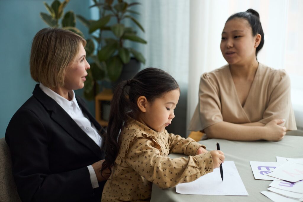 Family Lawyer with a Young Child with Teacher and Parent Observing