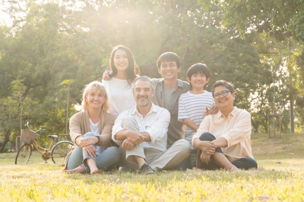 Group of family people sitting on grass at a park family trusts in divorce property settlement
