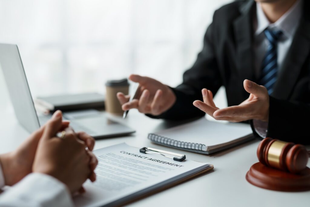 Businessman and lawyer discuss and advice on contract documents.