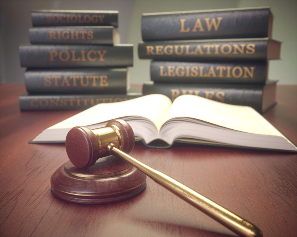 “Legal reference books and a judge’s gavel symbolizing legal requirements, regulations, and recent law changes.