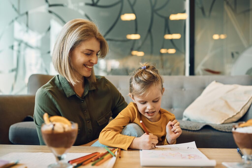 Happy mother and daughter enjoying in creative time at home.