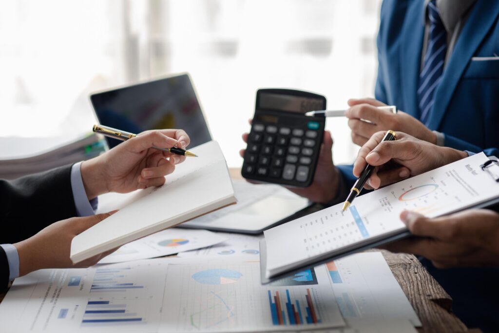 Businessman is reviewing monthly sales documents for analysis an