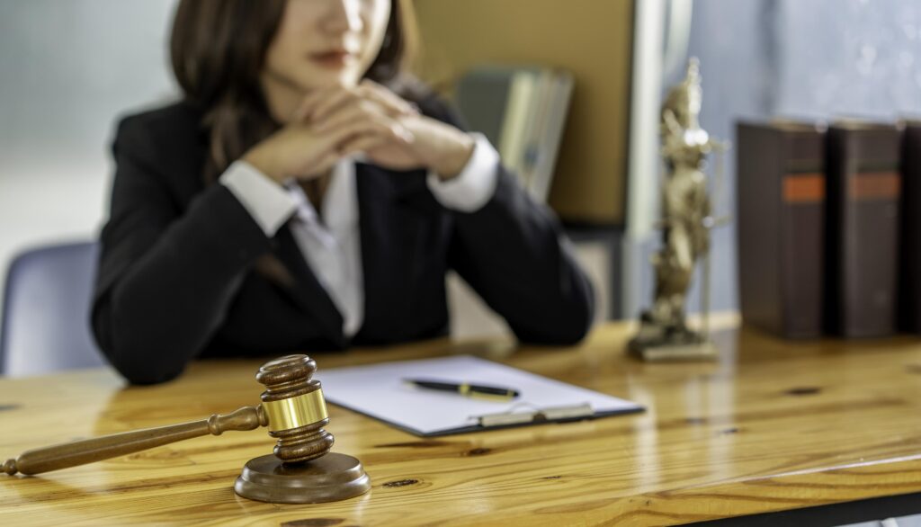 Lawyer with Gavel and Legal Document on Desk