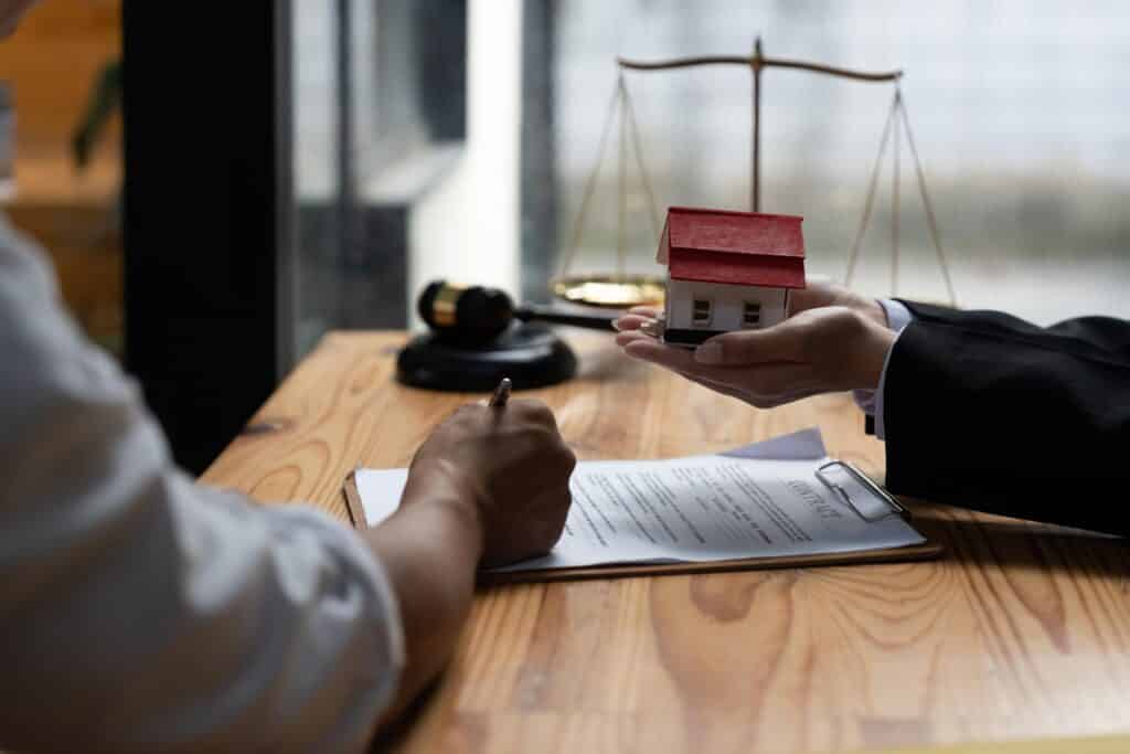 Purchase Agreement Being Signed at Desk
