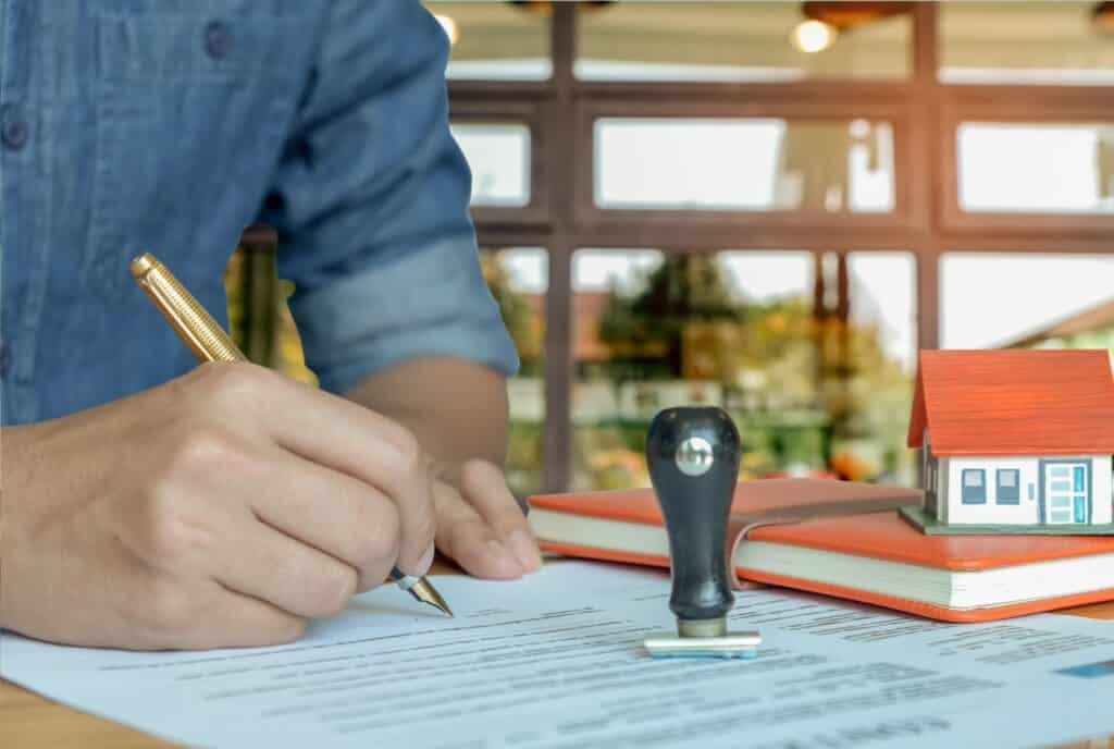 Signing Real Estate Contract with Model Home